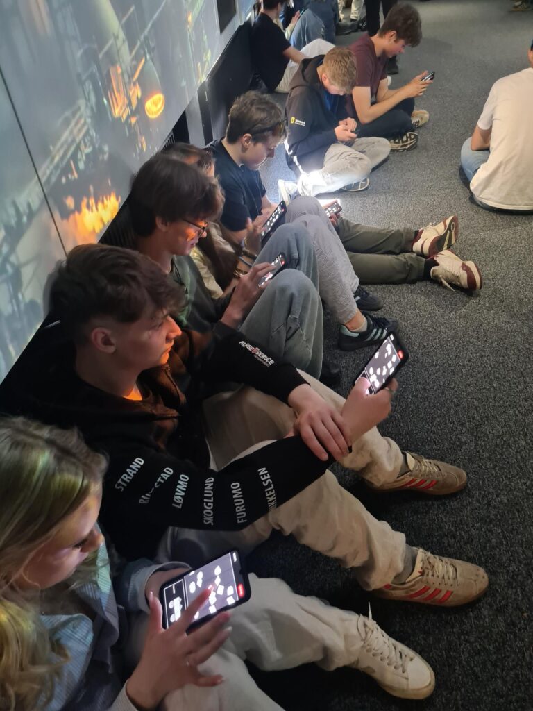 Young people participating in democracy learning scrolls on their phones